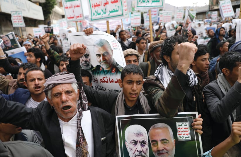 HOUTHI SUPPORTERS rally to denounce the US killing of Iranian military commander Qasem Soleimani and Iraqi militia commander Abu Mahdi alMuhandis, in Sana’a, Yemen, on January 6. The placards read, ‘God is the greatest, death to America, death to Israel, Curse on the Jews, victory to Islam.’ (photo credit: KHALED ABDULLAH/ REUTERS)