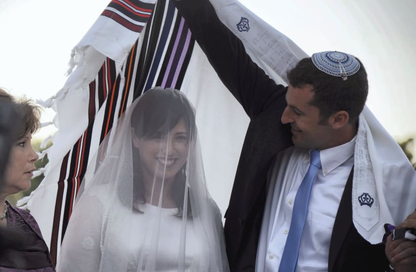 VEILED THEN-DEPUTY Transportation Minister Tzipi Hotovely stands with husband-to-be Or Alon at their 2013 wedding. Lester’s tome discusses the symbolism of the veil and other aspects of nuptial ceremonies. (photo credit: YOSSI ZELIGER/FLASH90)