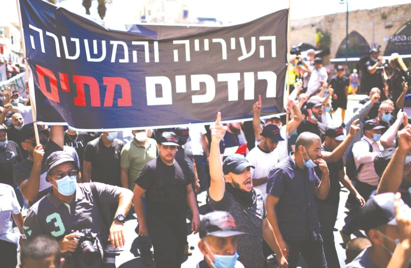 ARABS CITIZENS protest in Jaffa earlier this year, carrying a banner says that ‘The city and the police are chasing after the dead’ following a decision by the Tel Aviv Municipality to demolish an old Muslim burial ground which was discovered after plans had been made to build a homeless shelter and (photo credit: TOMER NEUBERG/FLASH90)