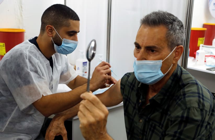 Bent spoon, straight needle: Uri Geller joins Israeli vaccine drive (photo credit: REUTERS)