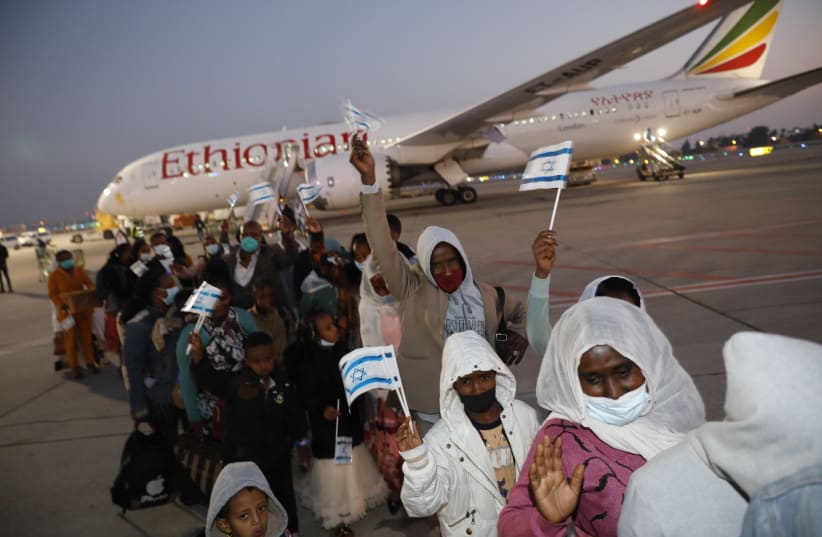 New Ethiopian immigrants are seen at Ben-Gurion Airport on one of the first aliyah flights of the new year, on January 1, 2021. (photo credit: OLIVIA FITOUSI/JAFI)
