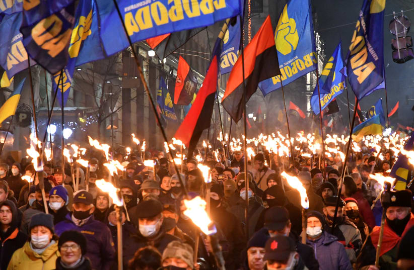 Participants of an annual event in honor of Stepan Bandera march through Kyiv, Ukraine on Jan. 1, 2021. (photo credit: GENYA SAVILOU/AFP VIA GETTY IMAGES)