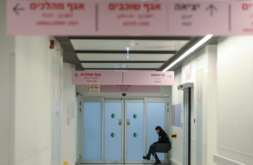 A woman is seen sitting in the hallway at Ashdod's Samson Assuta Hospital. (photo credit: MARC ISRAEL SELLEM/THE JERUSALEM POST)