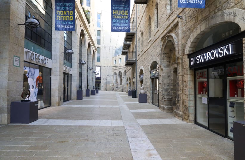 Jerusalem's Mamilla mall is seen nearly empty amid Israel's third coronavirus lockdown, on January 4, 2021. (photo credit: MARC ISRAEL SELLEM/THE JERUSALEM POST)