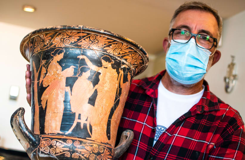 A Greek vase painted in the red-figure style with Head of the Anti-Theft Unit at the IAA Amir Ganor  (photo credit: YULI SCHWARTZ/IAA)