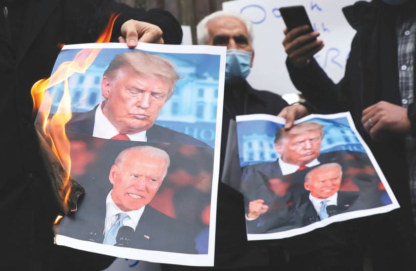 PROTESTERS BURN pictures of US President-elect Joe Biden and President Donald Trump, in Tehran, Iran, in November. (photo credit: MAJID ASGARIPOUR/WANA (WEST ASIA NEWS AGENCY) VIA REUTERS)