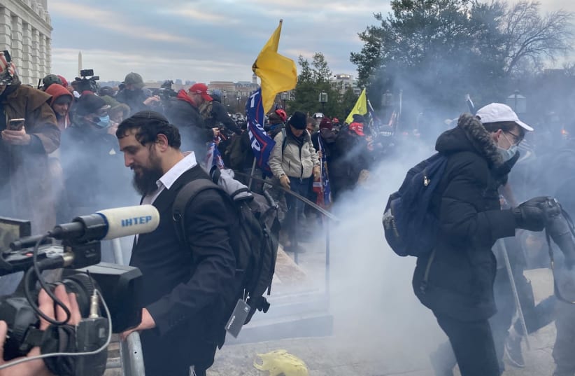 Security forces respond with tear gas after the US President Donald Trumps supporters breached the US Capitol security in Washington D.C. on January 6, 2021. (Tayfun Coskun/Anadolu Agency via Getty Images) (photo credit: GETTY IMAGES)