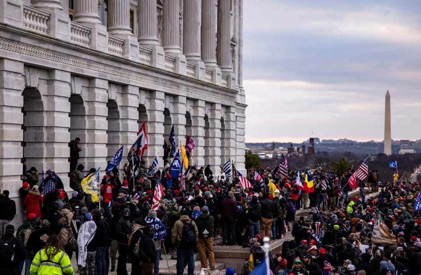 A pro-Trump mob storms the U.S. Capitol following a rally with President Donald Trump on January 6, 2021 in Washington, DC. Trump supporters gathered in the nation's capital today to protest the ratification of President-elect Joe Biden's Electoral College victory over President Trump in the 2020 el (photo credit: SAMUEL CORUM/GETTY IMAGES)