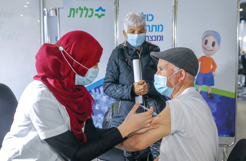 GETTING INOCULATED at a Jerusalem Clalit clinic this week (photo credit: MARC ISRAEL SELLEM/THE JERUSALEM POST)
