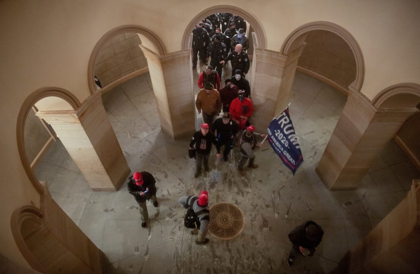 Pro-Trump protesters storm the U.S. Capitol during a rally to contest the certification of the 2020 US presidential election results by the US Congress, at the US Capitol Building in Washington, DC, US January 6, 2021.  (photo credit: REUTERS/AHMED GABER)