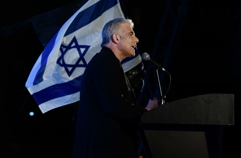 MK Yair Lapid speaks during a protest against Prime Minister Benjamin Netanyahu calling on him to quit, at Rabin Square in Tel Aviv on April 19, 2020. (photo credit: TOMER NEUBERG/FLASH90)