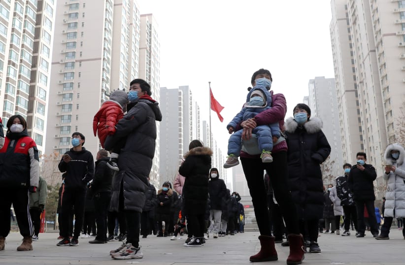 People line up for a second round of citywide nucleic acid testing at a residential compound in Shijiazhuang (photo credit: REUTERS)