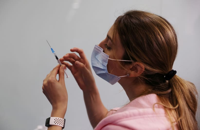 Israelis get vaccinated against COVID-19 (photo credit: REUTERS)