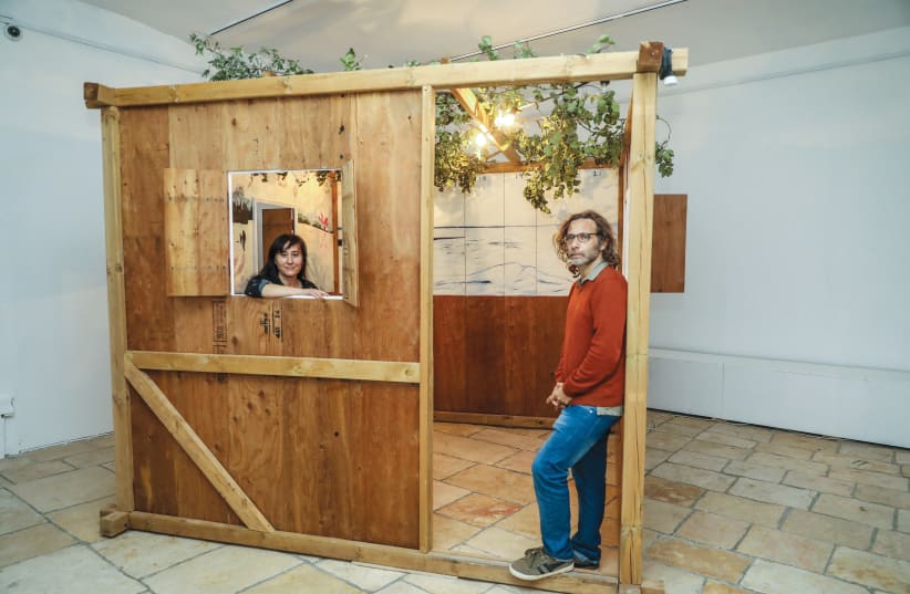 LEA MAUAS and Diego Rotman stand in one of the sukkot that are part of the ‘Permanent Residency’ exhibition. (photo credit: MARC ISRAEL SELLEM/THE JERUSALEM POST)
