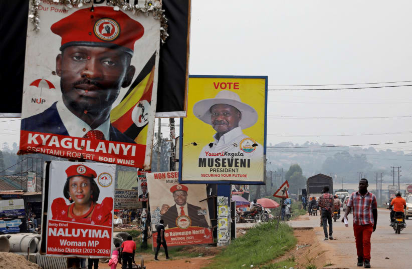 Elections billboards for Uganda's President Yoweri Museveni, and opposition leader and presidential candidate Robert Kyagulanyi, also known as Bobi Wine, are seen on a street in Kampala (photo credit: BAZ RATNER/REUTERS)