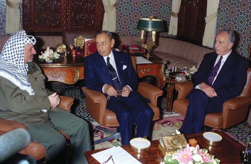MOROCCO’S KING HASSAN II (center) speaks with PLO leader Yasser Arafat and foreign minister Shimon Peres in the King’s Palace in Rabat, Morocco, 1995 (photo credit: REUTERS)