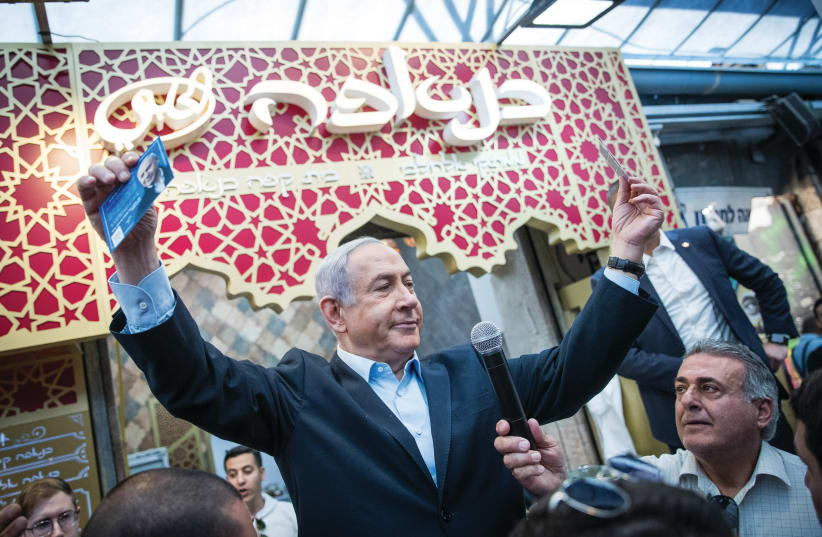 PRIME MINISTER Benjamin Netanyahu makes a pre-election visit to Jerusalem’s Mahaneh Yehuda market in February 2020 (photo credit: YONATAN SINDEL/FLASH 90)