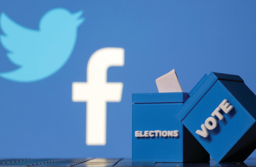 3D-PRINTED BALLOT BOXES are seen in front of Facebook and Twitter logos. (photo credit: DADO RUVIC/REUTERS)