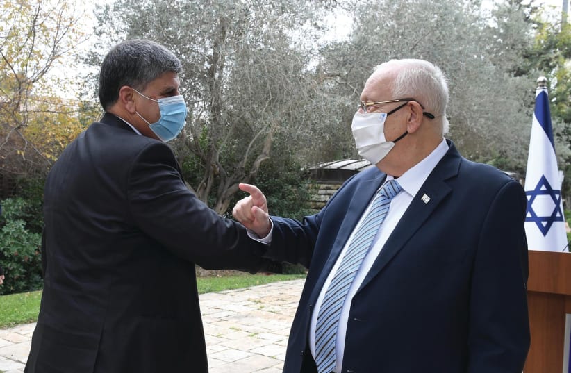 PRESIDENT REUVEN RIVLIN makes a point as he greets Umm el-Fahm Mayor Dr. Samir Mahmid. (photo credit: MARK NEYMAN/GPO)