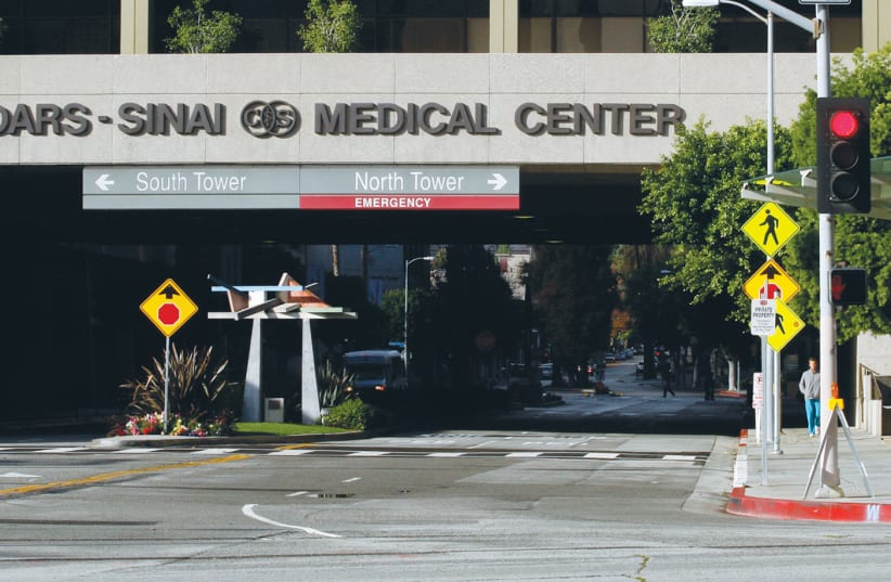 THE ENTRANCE TO Cedars-Sinai Medical Center in Los Angeles, which has been inundated with COVID-19 patients. (photo credit: BENOIT TESSIER/REUTERS)