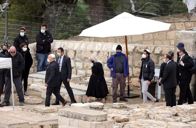 Miriam Adelson, wife of Sheldon Adelson attends his funeral in a cemetery in Jerusalem, January 15, 2021 (photo credit: REUTERS/Ronen Zvulun)
