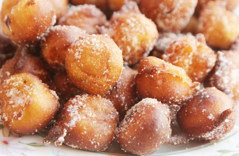 Bunuelos are small balls of fried dough with a sweet or salty filling.  (photo credit: THE NOSHER/JTA)
