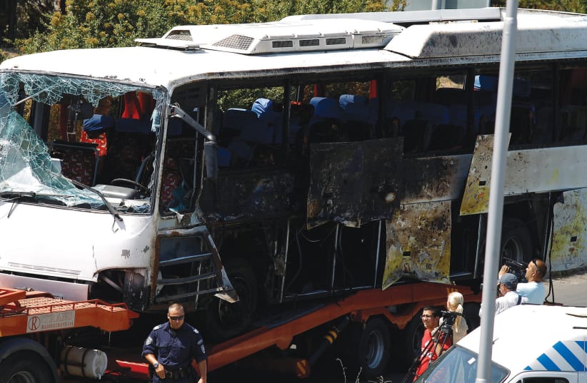 A bus shows the aftermath of a Hezballah attack that killed eight Israelis (photo credit: STOYAN NENOV/REUTERS)