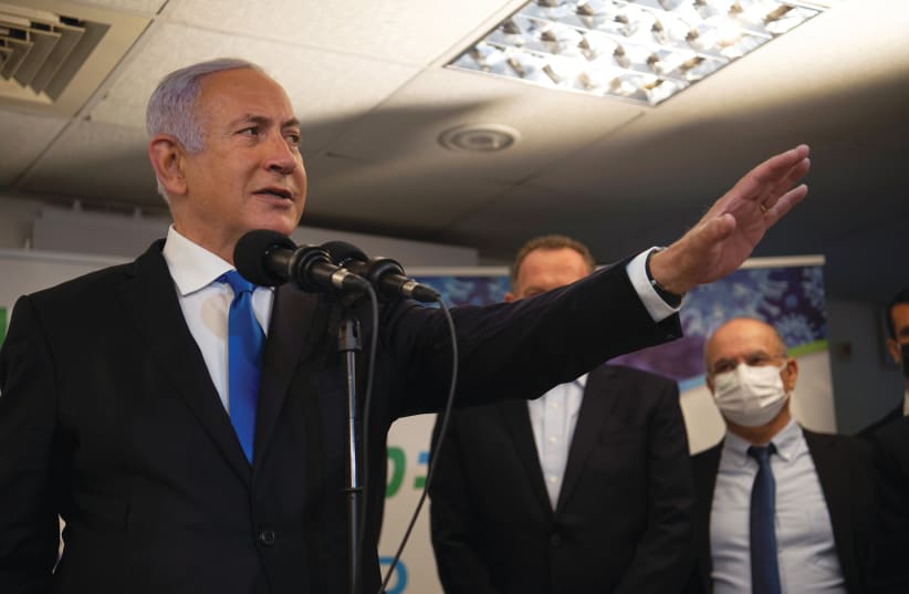 PRIME MINISTER Benjamin Netanyahu visits a coronavirus vaccination facility in Nazareth last Wednesday. (Gil Eliyahu/Reuters) (photo credit: GIL ELIYAHU/REUTERS)