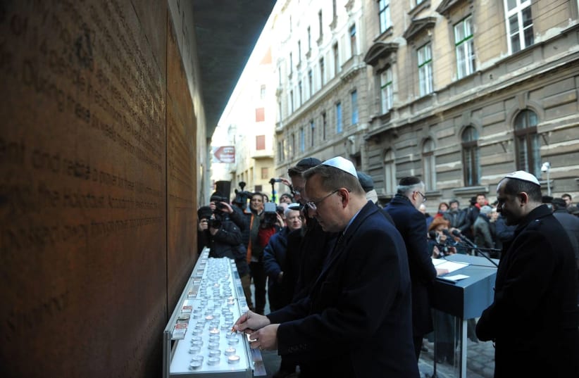 Visitors paying their respects to the memory of the Jews of Budapest taken in 2018  (photo credit: EMIH)