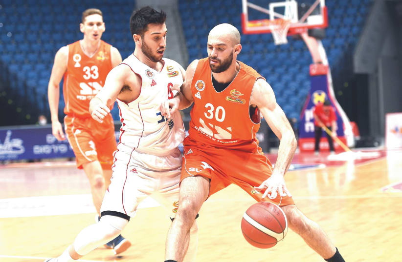 NIMROD TISHMAN (30) and Maccabi Rishon Lezion were too strong for Tamir Blatt and Hapoel Jerusalem on Sunday night, pulling out a 79-73 Balkan League win.  (photo credit: BERNEY ARDOV)
