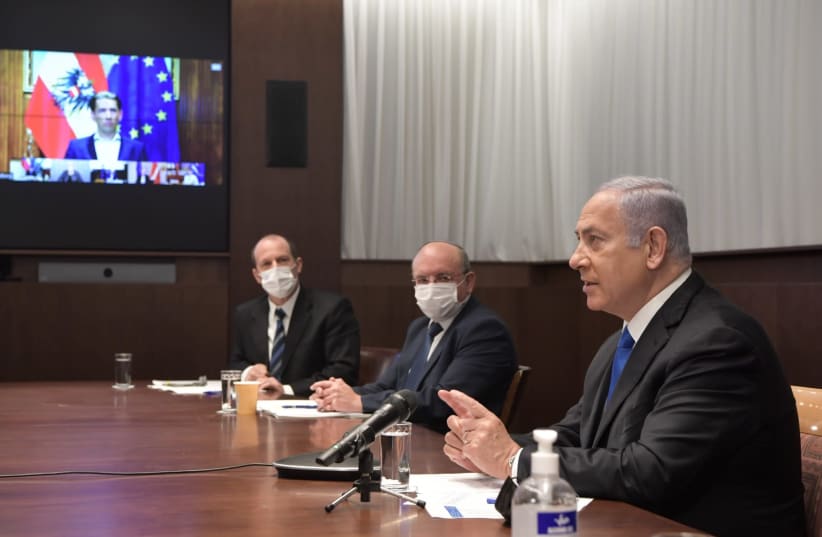 Prime Minister Benjamin Netanyahu is seen in a video conference with other world leaders discussing an international vaccine initiative, on January 18, 2021. (photo credit: KOBI GIDEON/GPO)