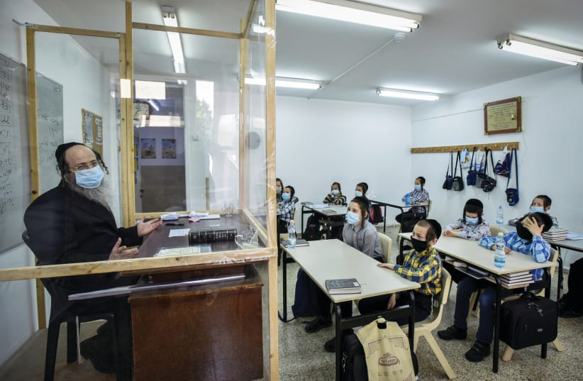 Ultra Orthodox students listen to their socially-distanced teacher at their school in Rehovot in September (photo credit: YOSSI ZELIGER/FLASH90)