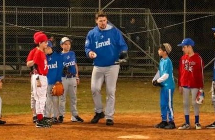 MAJOR LEAGUER and Israel Olympic National Team catcher Ryan Lavarnway (center) coaches young Israeli baseball players at the Baptist Village in 2019. (photo credit: Courtesy)