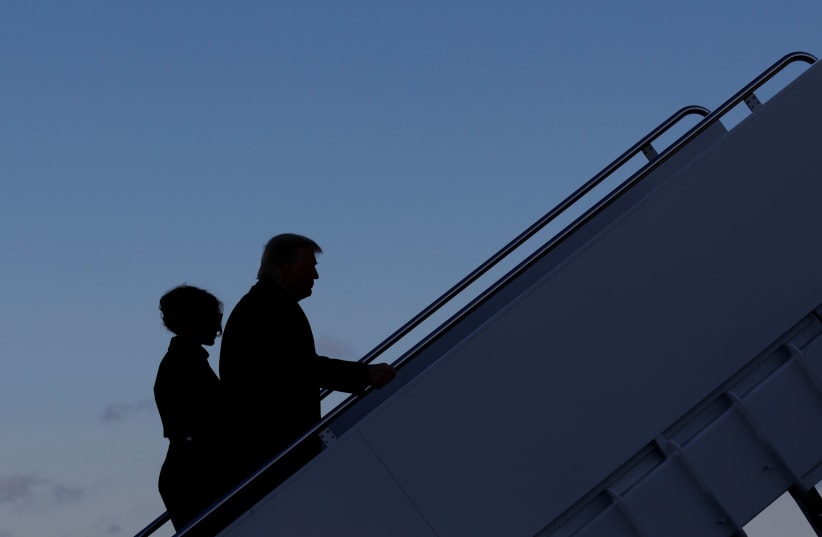 US President Donald Trump departs next to first lady Melania Trump from the Joint Base Andrews, Maryland, US, January 20, 2021. (photo credit: CARLOS BARRIA / REUTERS)