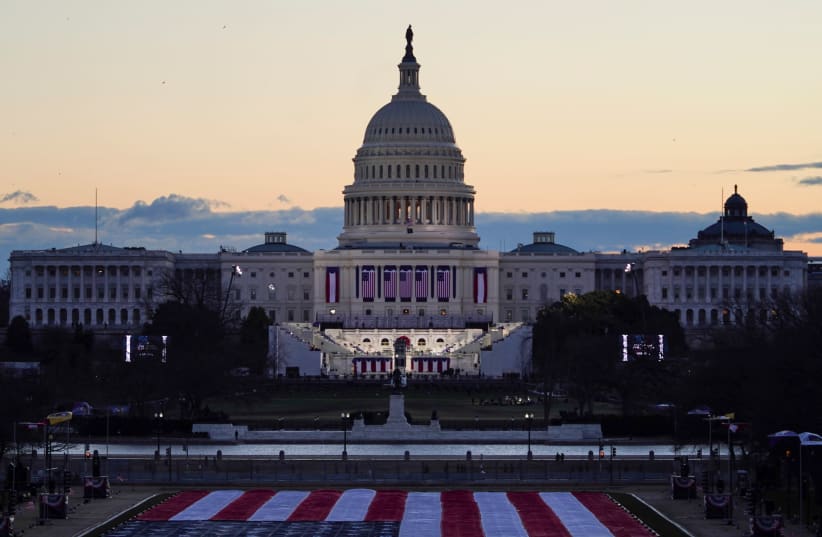 The "Field of flags" is seen on the National Mall in front of the U.S. Capitol building ahead of inauguration ceremonies for President-elect Joe Biden in Washington, US, January 20, 2021. (photo credit: REUTERS/ALLISON SHELLEY)
