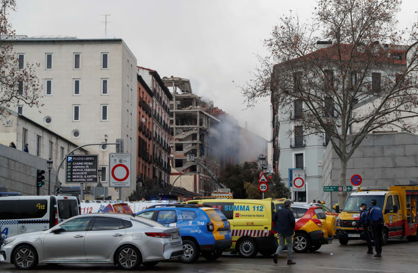 Smoke rises from the site of an explosion in Madrid downtown, in Madrid Spain January 20, 2021. (photo credit: REUTERS/SUSANA VERA)