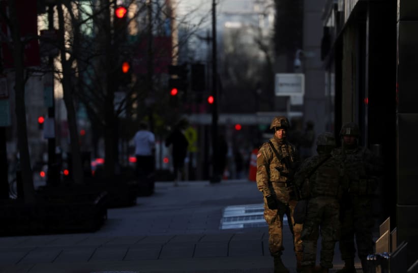National Guard troops are seen near the secured zone set up for the inauguration of Joe Biden as the 46th President of the United States, near Black Lives Matter Plaza, in Washington DC, US, January 20, 2021.  (photo credit: REUTERS/LEAH MILLIS)