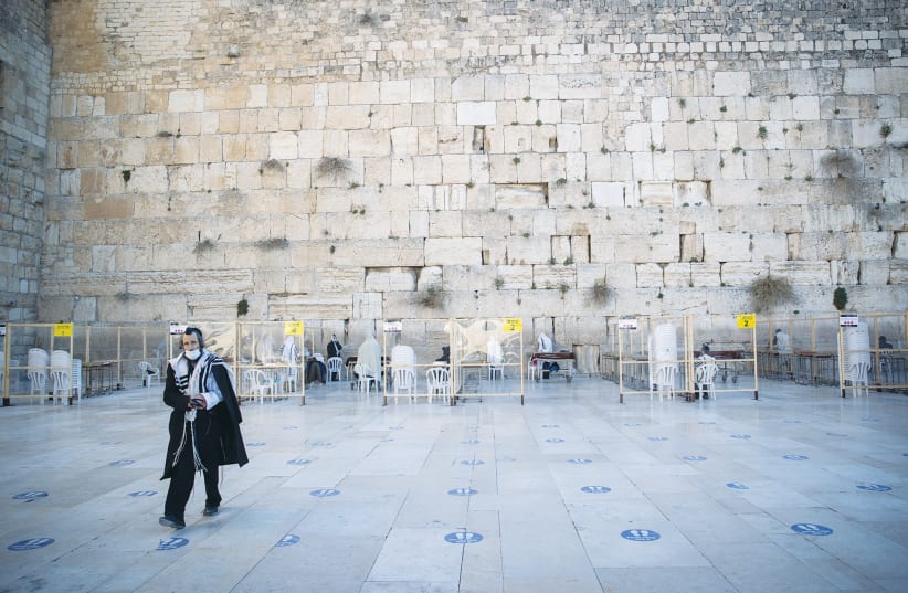 A MAN walks away from the Western Wall earlier this month. (photo credit: YONATAN SINDEL/FLASH 90)