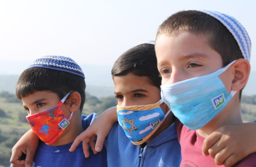 PUPILS OF the Gevim School in Beersheba wear masks designed by British schoolchildren.  (photo credit: Courtesy)
