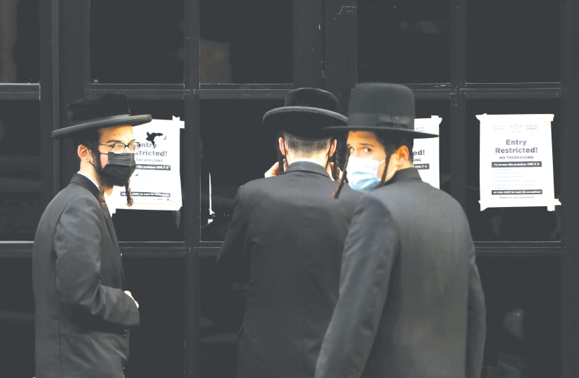 HAREDIM GATHER near the Congregation Yetev Lev D’Satmar synagogue in the South Williamsburg neighborhood of Brooklyn, last year.  (photo credit: ANDREW KELLY / REUTERS)