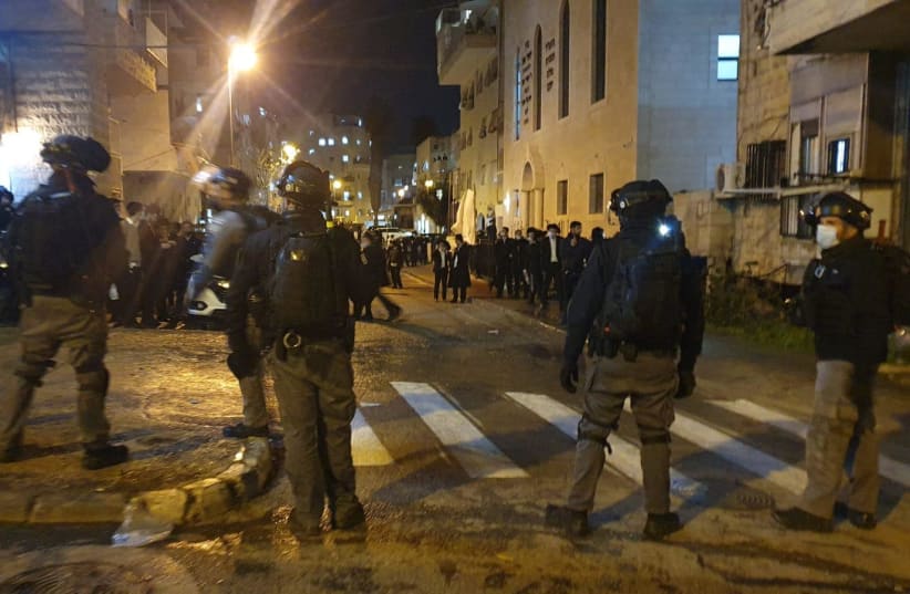 Israel Police face protesters fighting against the construction of the light rail in Jerusalem, January 25, 2021.  (photo credit: POLICE SPOKESPERSON'S UNIT)