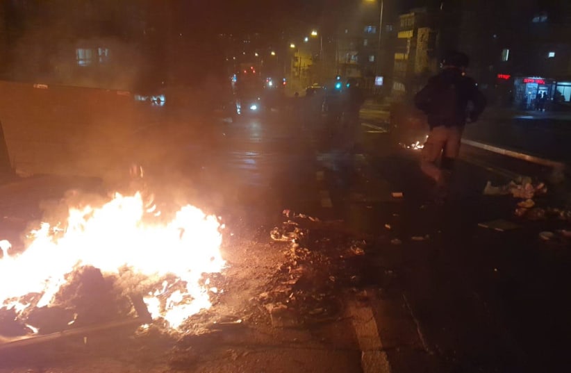 Haredi protesters burn garbage in protest of the light rail construction in their ultra-Orthodox neighborhood in Jerusalem, January 25, 2021.  (photo credit: POLICE SPOKESPERSON'S UNIT)