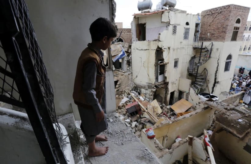 A Yemeni boy looks at the destruction caused by civil war at a World Heritage site in the Old City of Sana’a. (photo credit: FELTON DAVIS)