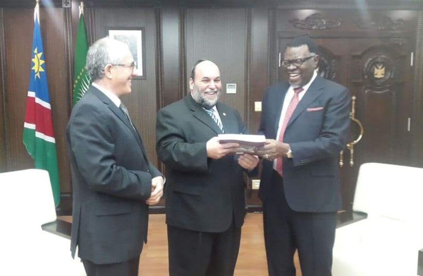 After non-resident Israeli Ambassador Gershon Kedar presented his credentials at State House in Windhoek, Rabbi Moshe Silberhaft hands Namibia’s President Hage Geingob a copy of the book, ‘The Jewish Community of South West Africa Namibia: A History. (photo credit: COURTESY RABBI SILBERHAFT)