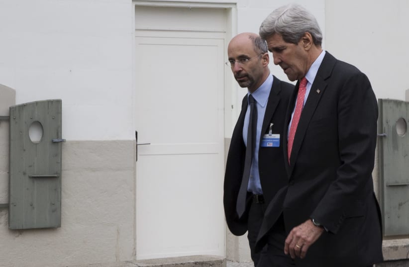 United States Secretary of State John Kerry walks to lunch with members his negotiating team, including Robert Malley (L) from the U.S. National Security Council, following a meeting with Iran's Foreign Minister Javad Zarif over Iran's nuclear program in Lausanne March 20, 2015 (photo credit: REUTERS)