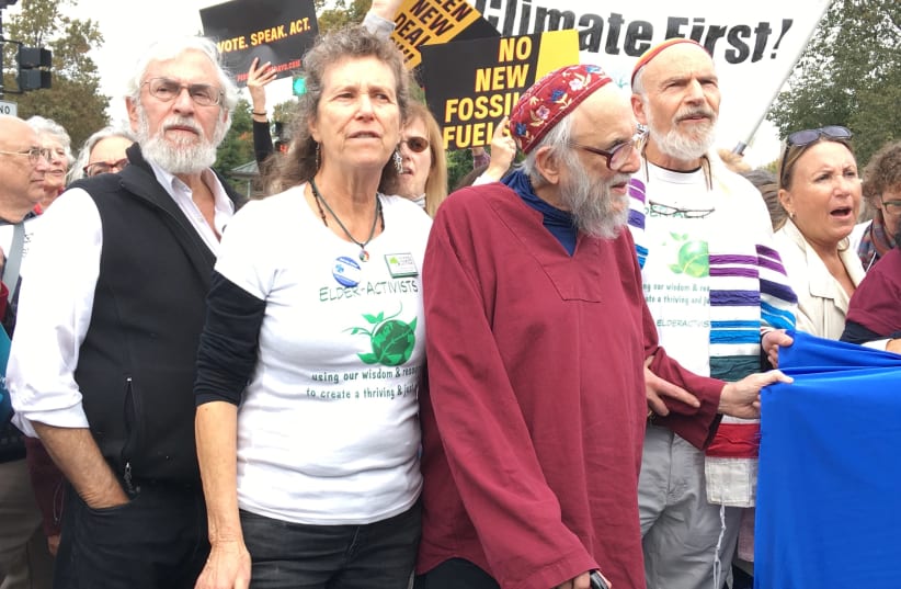 Rabbi Arthur Waskow, in red, at a climate protest in Philadelphia. (photo credit: MORDECHAI LIEBLING)