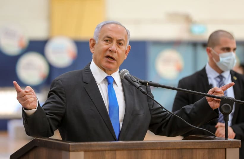 Prime Minister Benjamin Netanyahu is seen speaking at a COVID-19 vaccination center in Sderot, on January 27, 2021. (photo credit: LIRON MOLDOVAN/POOL)
