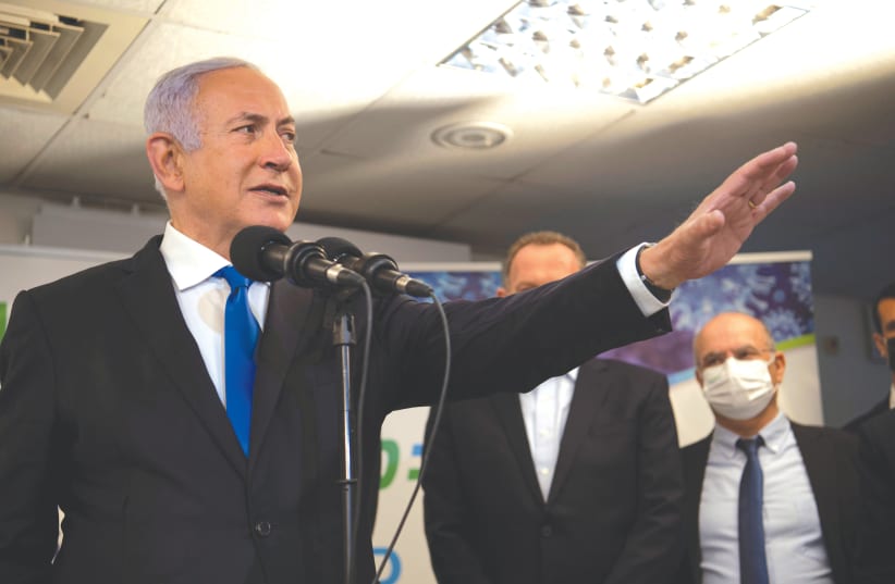 PRIME MINISTER Benjamin Netanyahu visits a coronavirus vaccination facility in Nazareth earlier this month. (photo credit: GIL ELIYAHU/REUTERS)