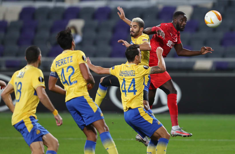 Maccabi Tel Aviv plays a Europa League soccer game at Bloomfield Stadium in their home city last year. The novel uses soccer as a vehicle to tell complex stories about Israeli society (photo credit: AMMAR AWAD / REUTERS)