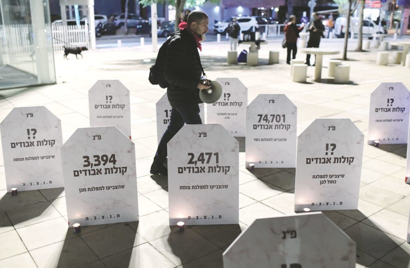 MOCK GRAVESTONES mark a protest in Tel Aviv two weeks ago calling for left-wing and centrist parties to unite ahead of the elections. (photo credit: TOMER NEUBERG/FLASH90)